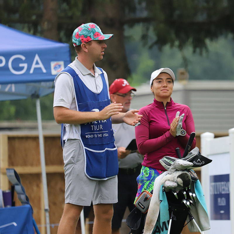 Fernanda Lira and caddie standing at teebox