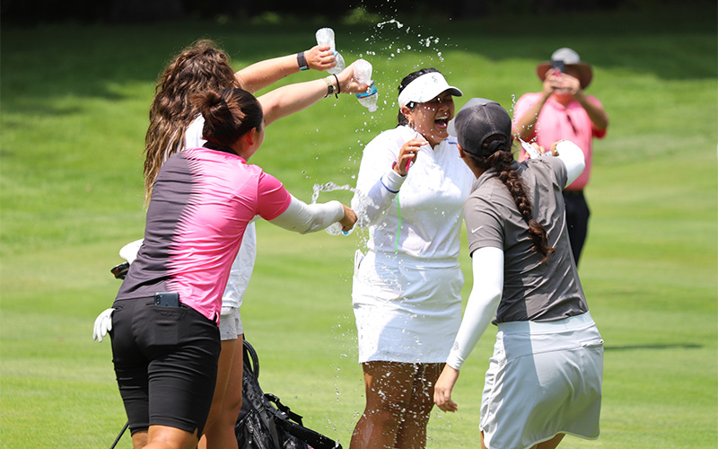 Group shot of girls pouring water on winner Vivia Lu