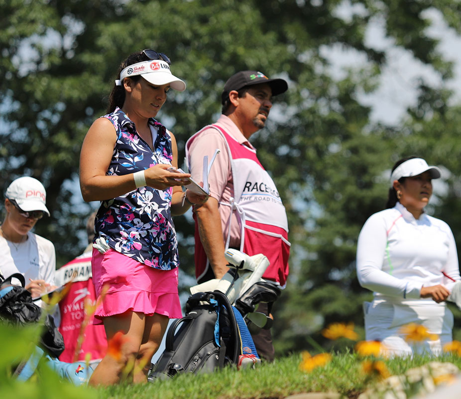 Rachel Rohanna teeing off with caddie