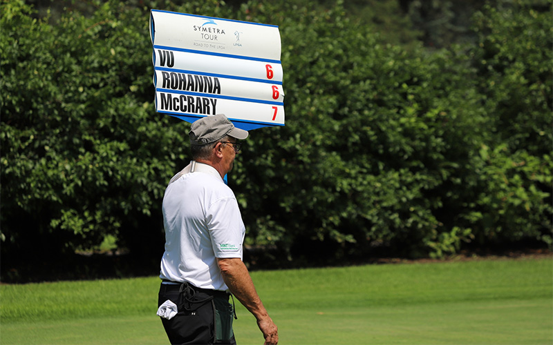 Man holding scoring sign